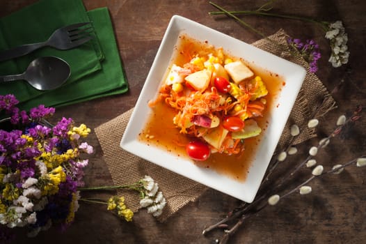 Thai mix fruit spicy dressed salad with low key scene