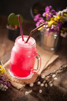 Red frozen cocktail on wood table in vintage stye with low key scene