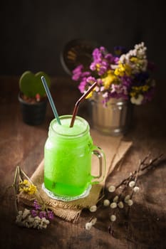 Green frozen cocktail on wood table in vintage stye with low key scene