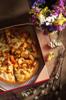 Pizza with roasted Chicken Breast, vegetables and Mozzarella Cheese in vintage style with low key scene