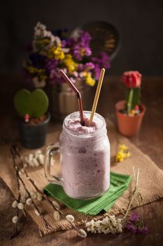 Blueburry smoothies on wood table in vintage style with low key scene
