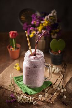 Blueburry smoothies on wood table in vintage style with low key scene