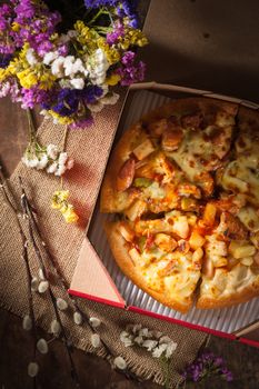 Pizza with roasted Chicken Breast, vegetables and Mozzarella Cheese in vintage style with low key scene