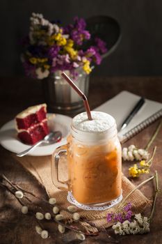 Thai tea with milk cream in cafe with low key scene