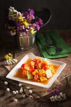 Thai mix fruit spicy dressed salad with low key scene