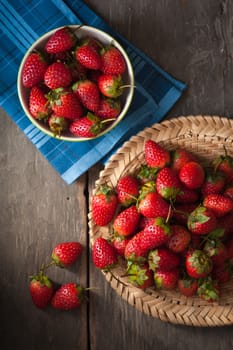 Strawberries on wood background in vintage style with low key scene.