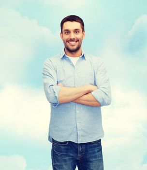 happiness and people concept - smiling man with crossed arms