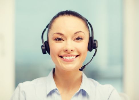 business, communication and call center concept - female helpline operator with headphones