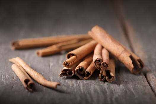 Cinnamon sticks on wood table with low key scene