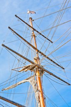 upwards view of a ship's masts on blue sky