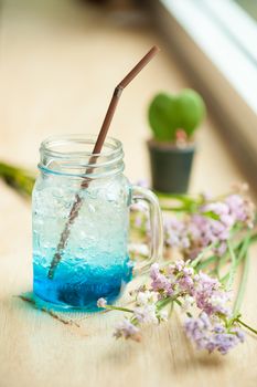 Blue Italian soda on wood bar in cafe