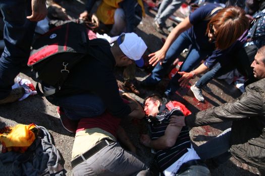 TURKEY, Ankara : People try to help wounded victims of a terror attack which killed at least 30 people in Ankara, capital city of Turkey on October 10th, 2015. Twin explosions outside Ankara's main train station on the morning appear to have targeted hundreds of people who had gathered to protest violence between authorities and Kurdish separatist group, the PKK.