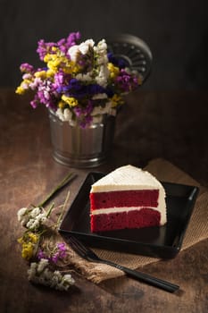 Red velvet cake on wood table with low key scene