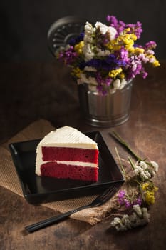 Red velvet cake on wood table with low key scene
