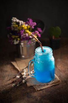 Blue cocktail frozen on wood bar in cafe