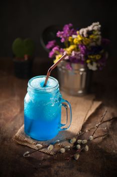 Blue cocktail frozen on wood bar in cafe
