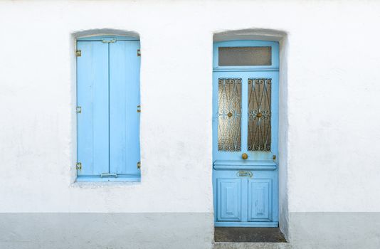 Detail of a white house with blue shutters and door in Noirmoutier-en-l'Île, France