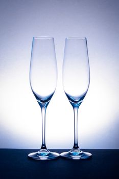 empty champagne glass on blue spot background