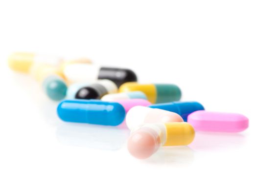 closeup of medical pills on white table