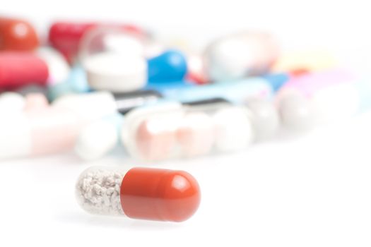 closeup of one medical pill in laboratory on white table