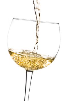 begin filled the white wine into glass tilted with space for text on a white background