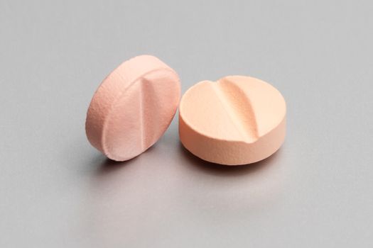 pink medical pills on metallic table 