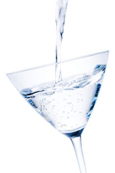 white cocktail tilted with blue reflections and bubbles on white background