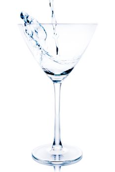 white cocktail with blue reflections and splashing on white background