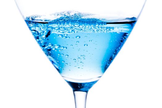 detail of blue cocktail with bubbles on a white background
