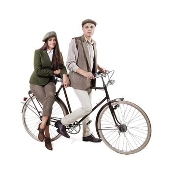 Vintage dressed couple sitting on retro bike