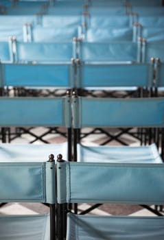 composition of blue canvas folding chairs empty