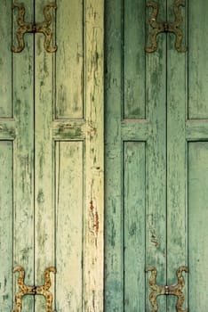 Detail of green wooden shutters of an old Italian villa.