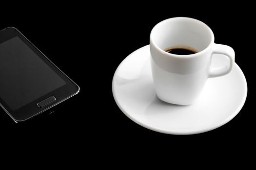 black smartphone and cup of coffee on black table