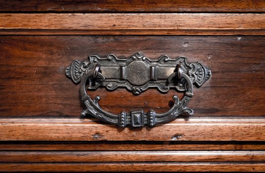 Brass handle hand made of the drawer of an antique furniture.