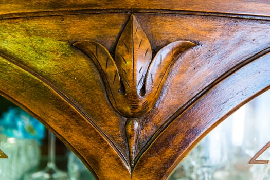 detail of an old carved wood cabinet crystals