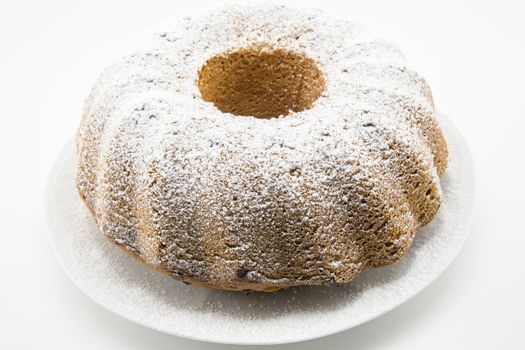 classic italian cake with icing sugar and hole in the center