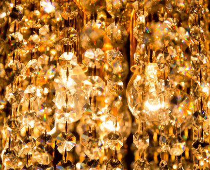 background created by a crystal chandelier that shines with golden light