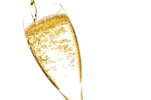 champagne flute with golden fine bubbles on white background