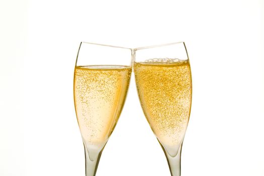 cheers, two champagne glasses with gold bubbles on white background