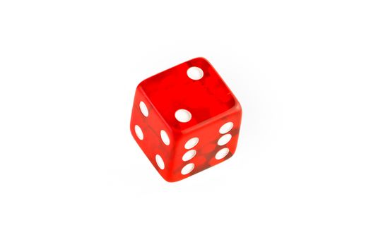 one transparent red die on a white background