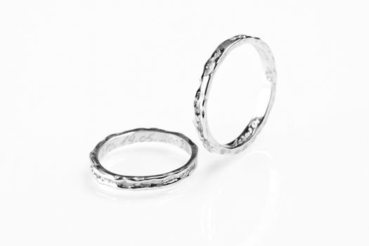 two white gold rings on white background