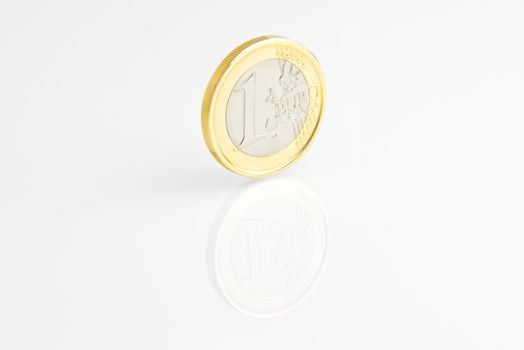 one euro coin reflected on white background