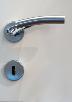 Modern, contemporary satin handle on a wooden door