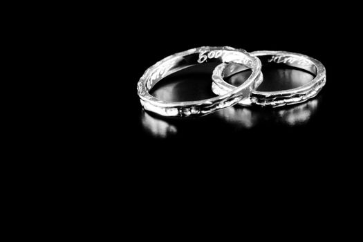 two white gold rings stacked together on black background