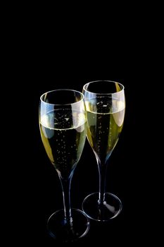 a glass of champagne on a black background.