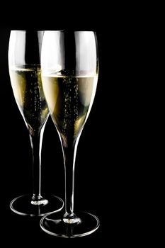 two glass with champagne on a black background