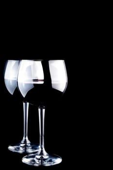 two glasses of wine on black background