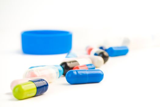 closeup of colored pills on white background