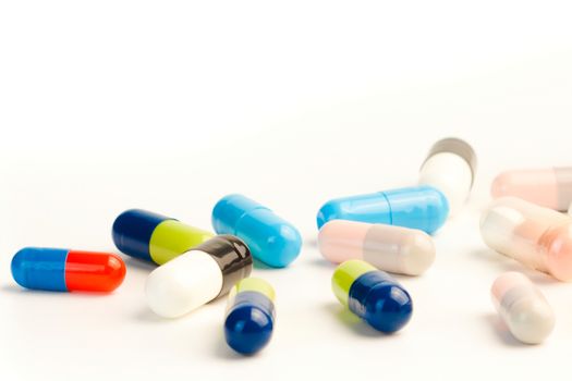 detail of many colorful pills on white background with space for text