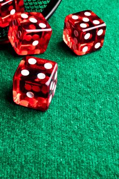 detail of red dice in corner in of a green table